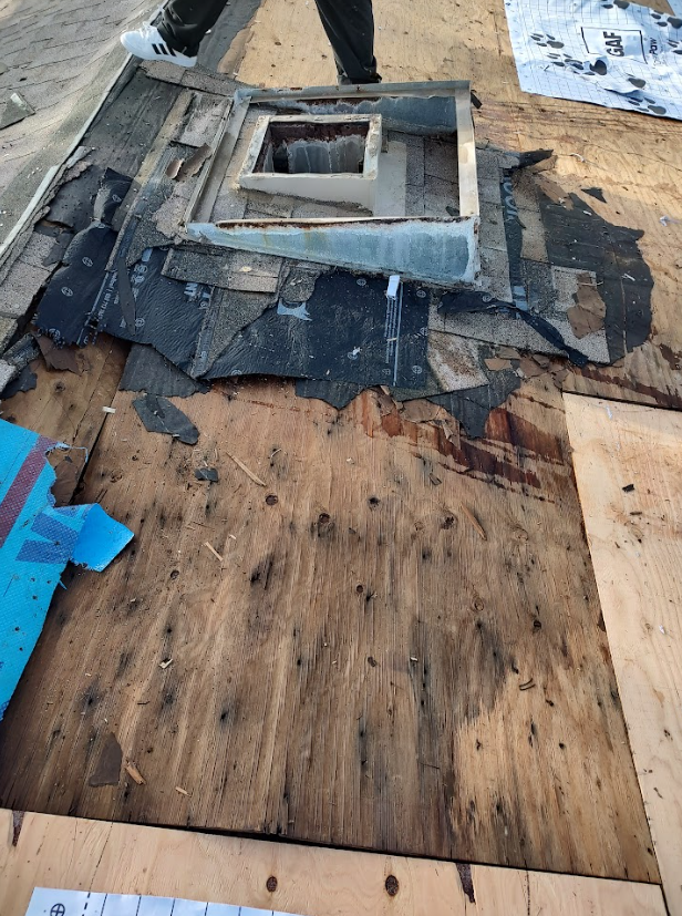 An aerial view of a roof of a house with a chimney.