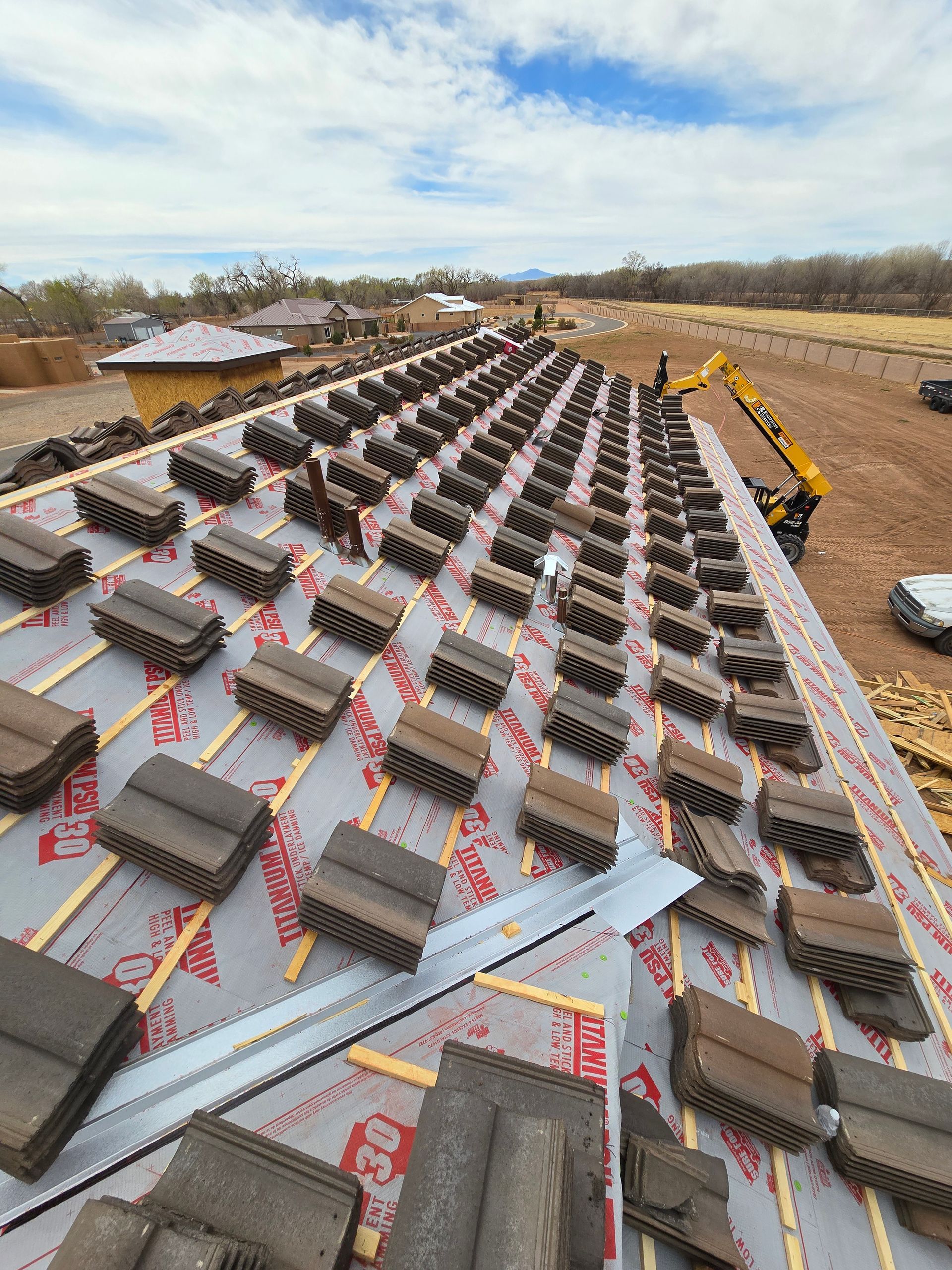 A large roof with a lot of tiles on it is being built.