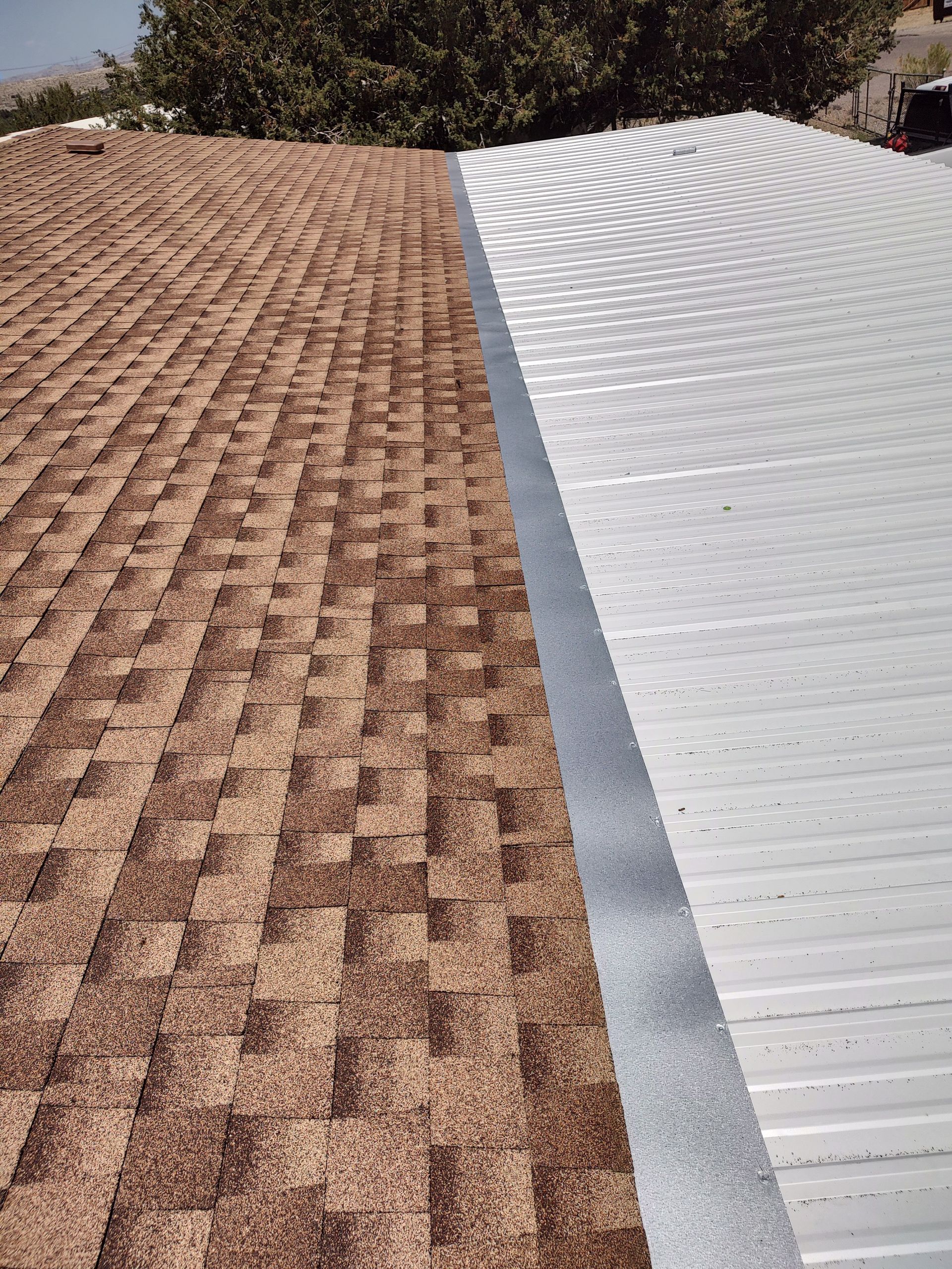 A close up of a brown roof next to a white roof.
