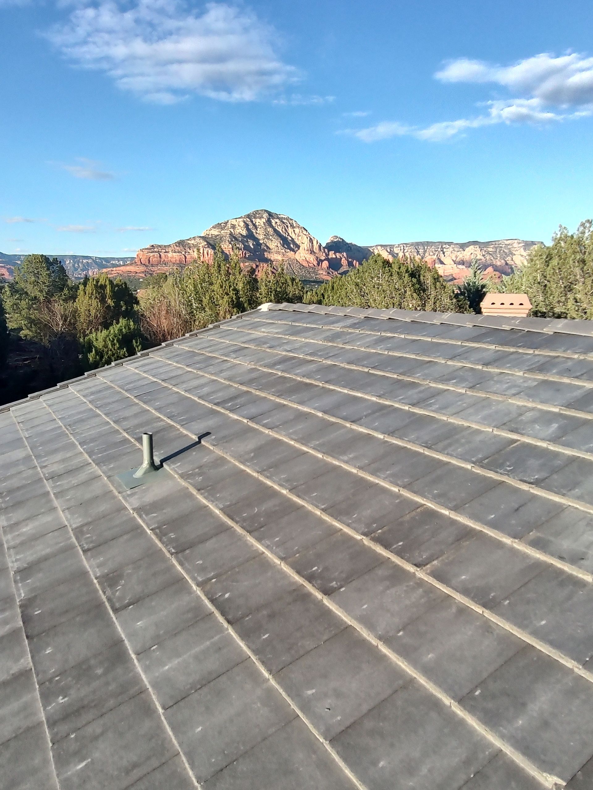 The roof of a building with mountains in the background