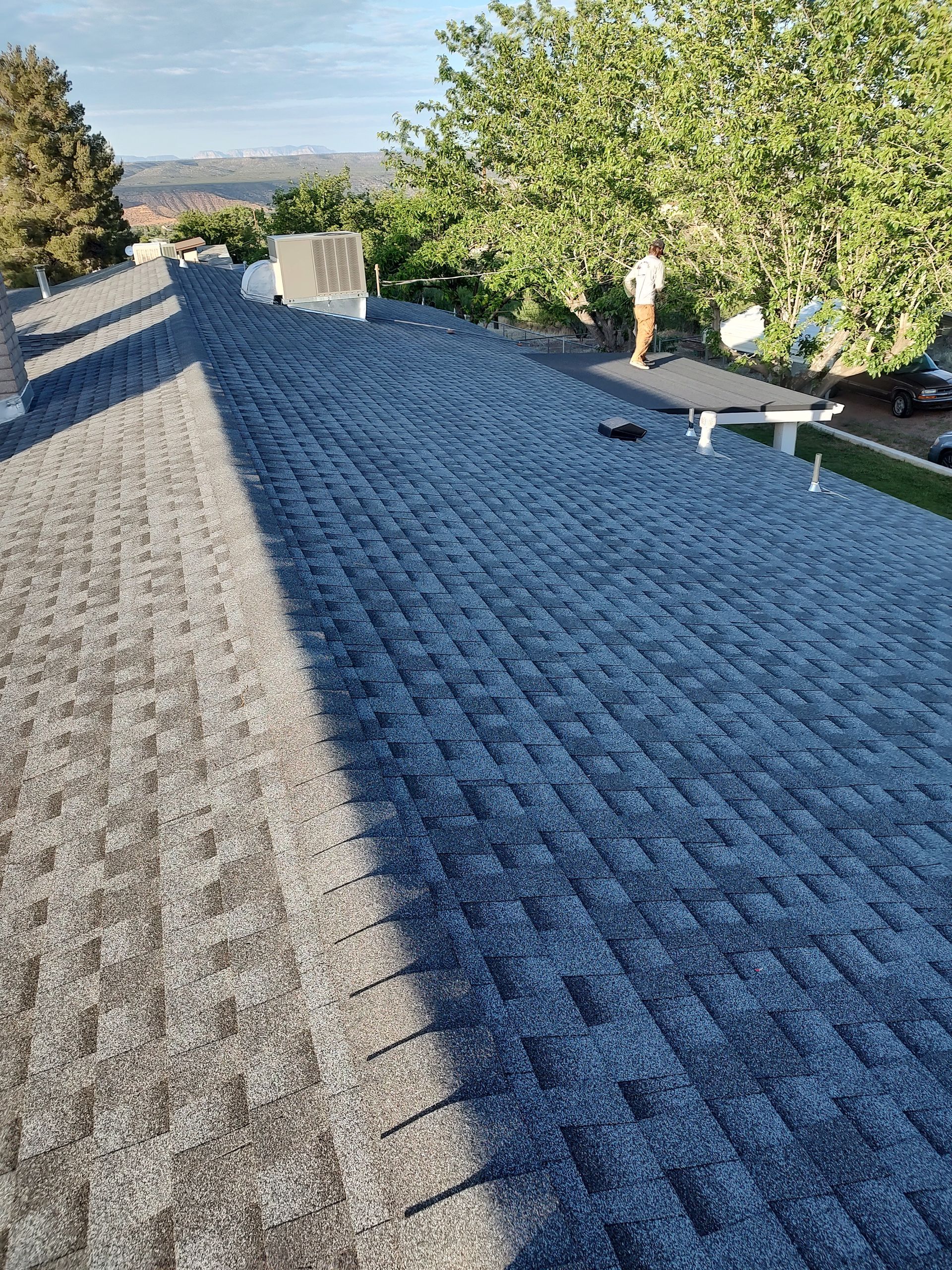 A chimney on the roof of a house with a blue sky in the background.