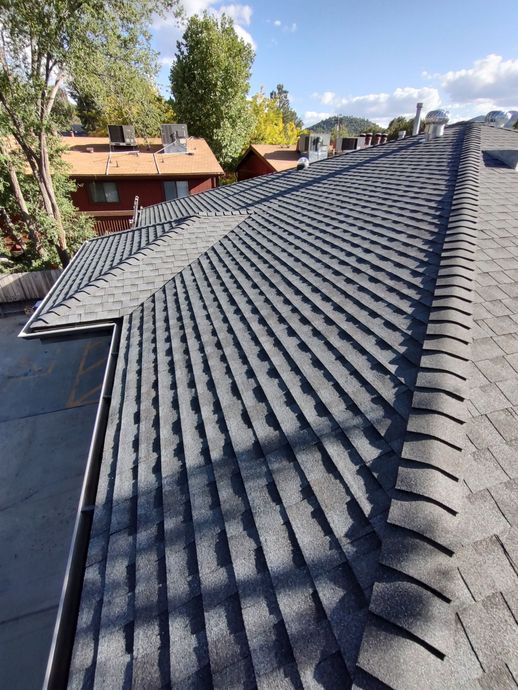 An aerial view of a house under construction with a blue roof.