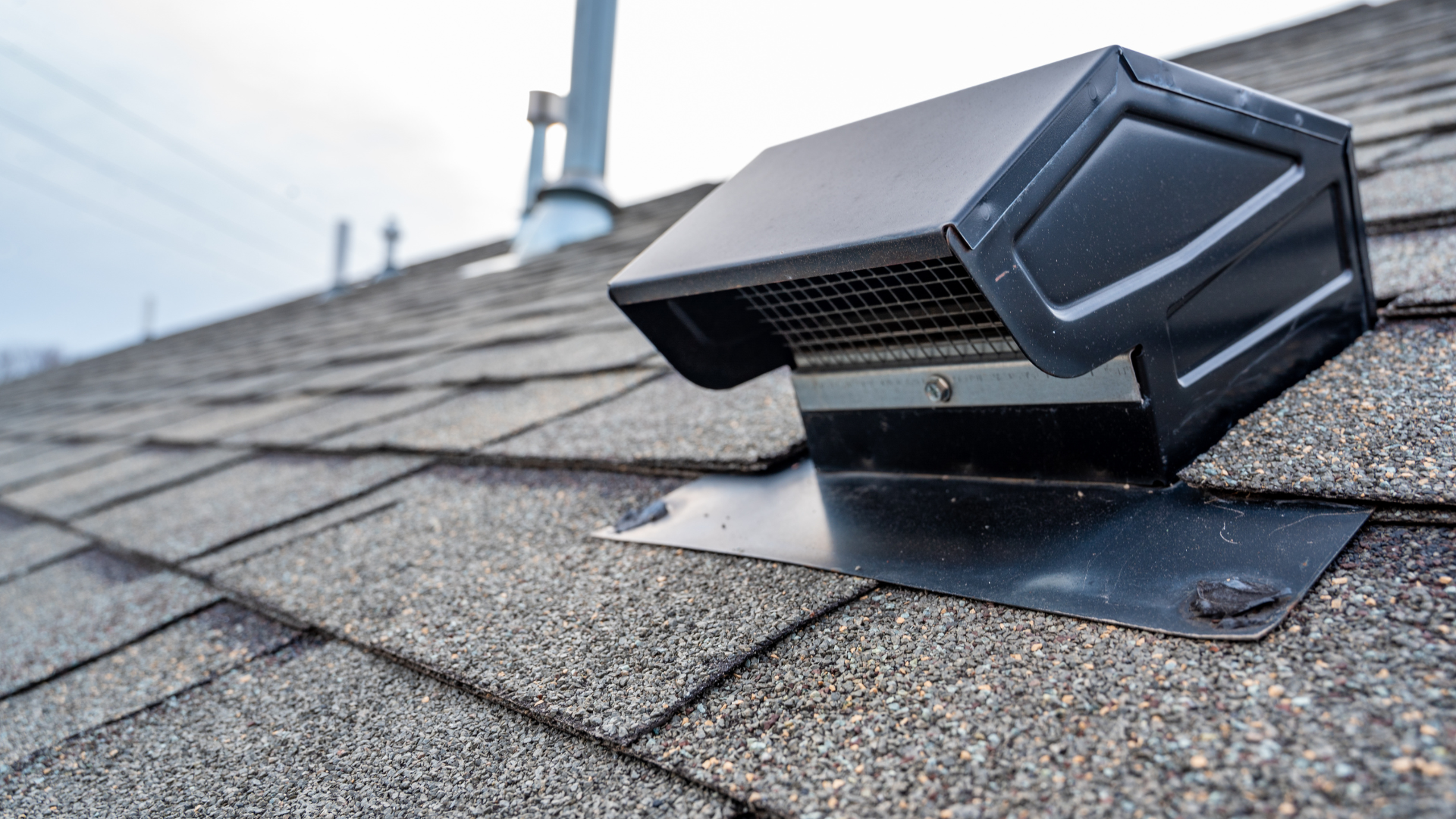 A roof vent is sitting on top of a roof.
