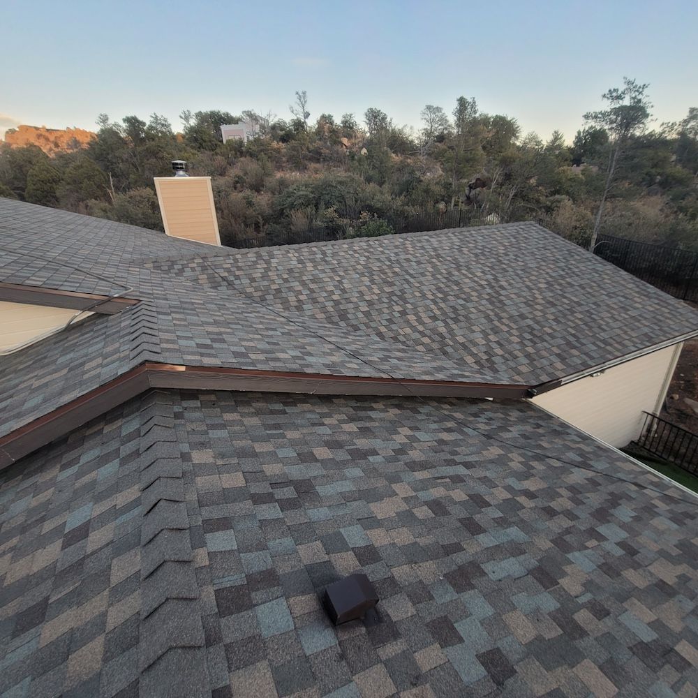 A roof of a house with a chimney on top of it.