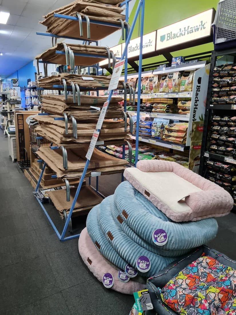 Bunch of Dog Beds Are Stacked on Top of Each Other in a Store — Rocky Pet World in Norman Gardens, QLD