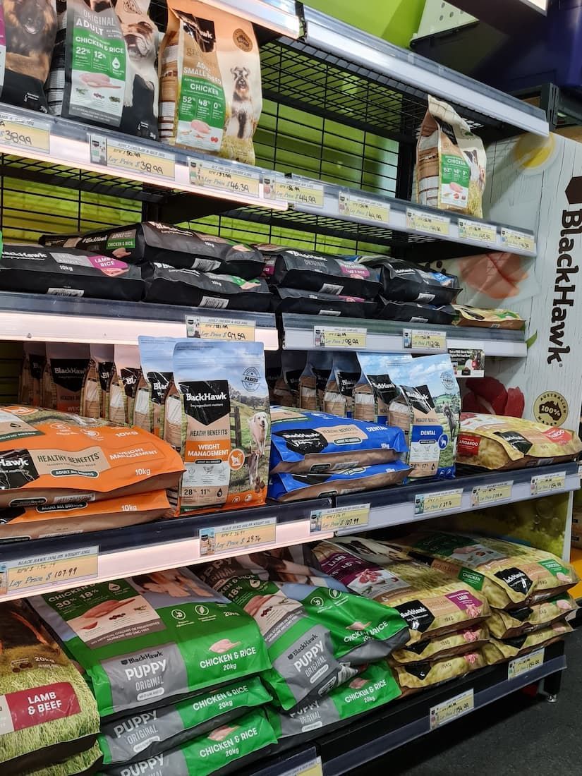 Shelf Filled With Bags of Dog Food in a Store — Rocky Pet World in Norman Gardens, QLD