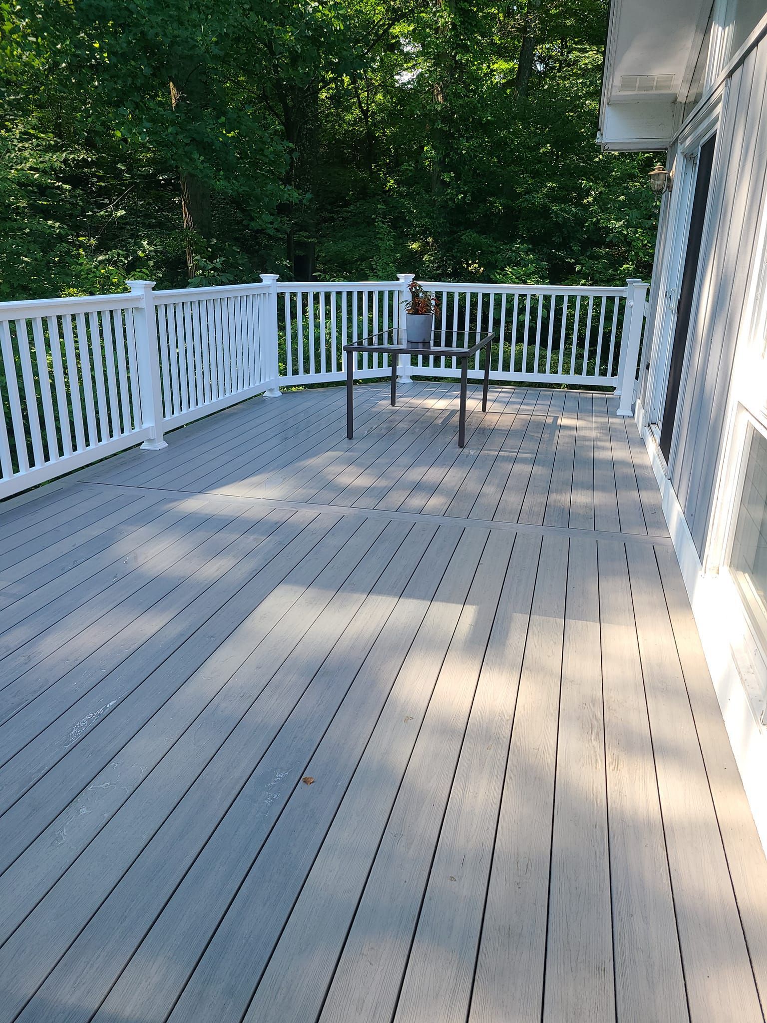 A large deck with a table and chairs on it