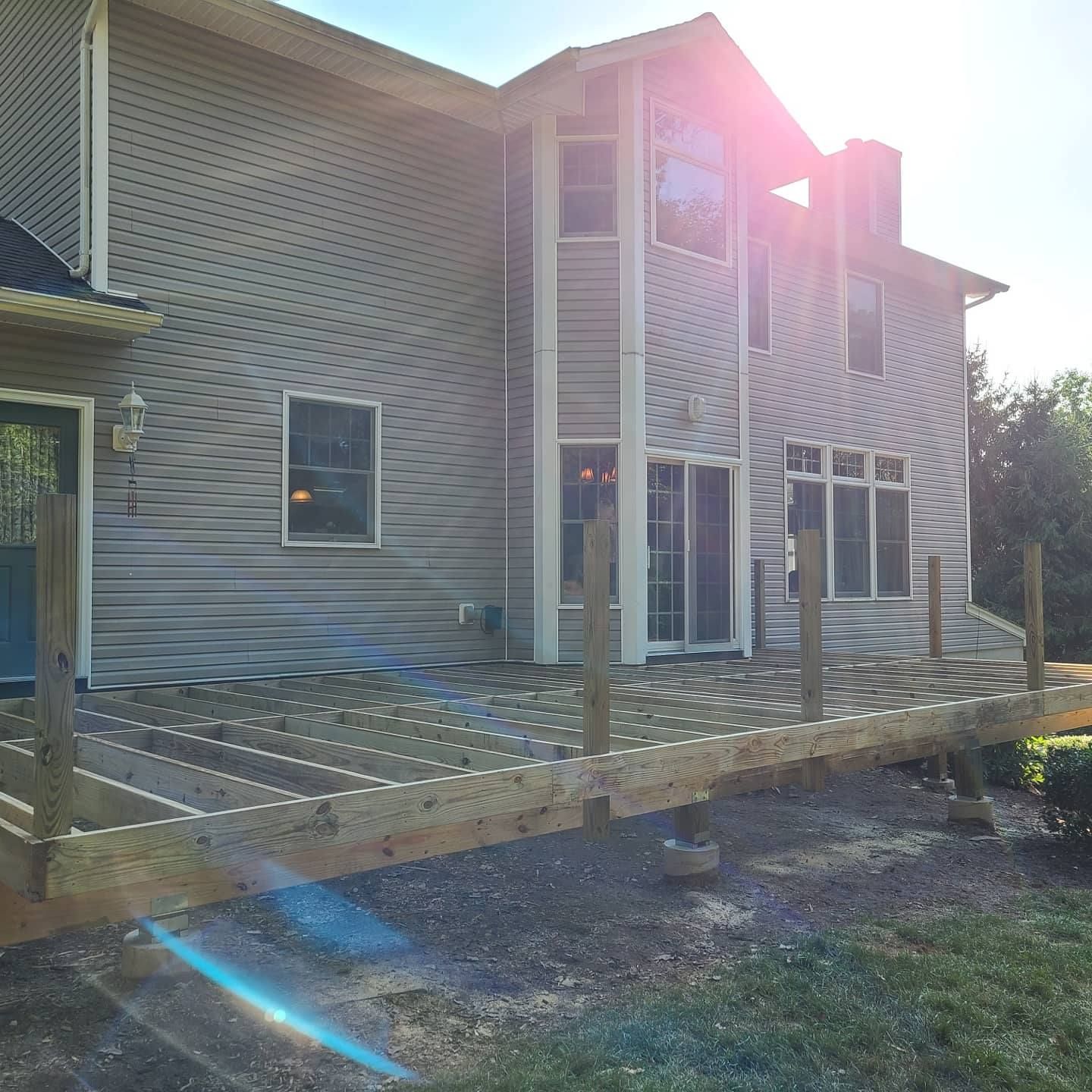 A large house with a wooden deck in front of it