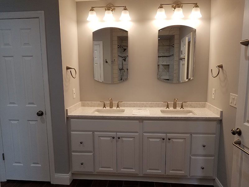 A bathroom with two sinks and two mirrors.