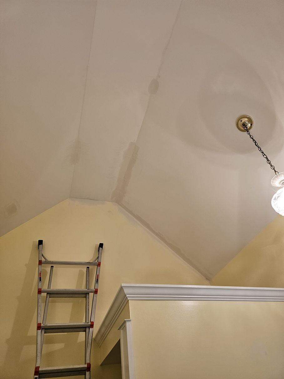 A ladder is hanging from the ceiling of a room