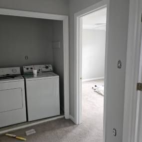 A laundry room with a washer and dryer in a closet.