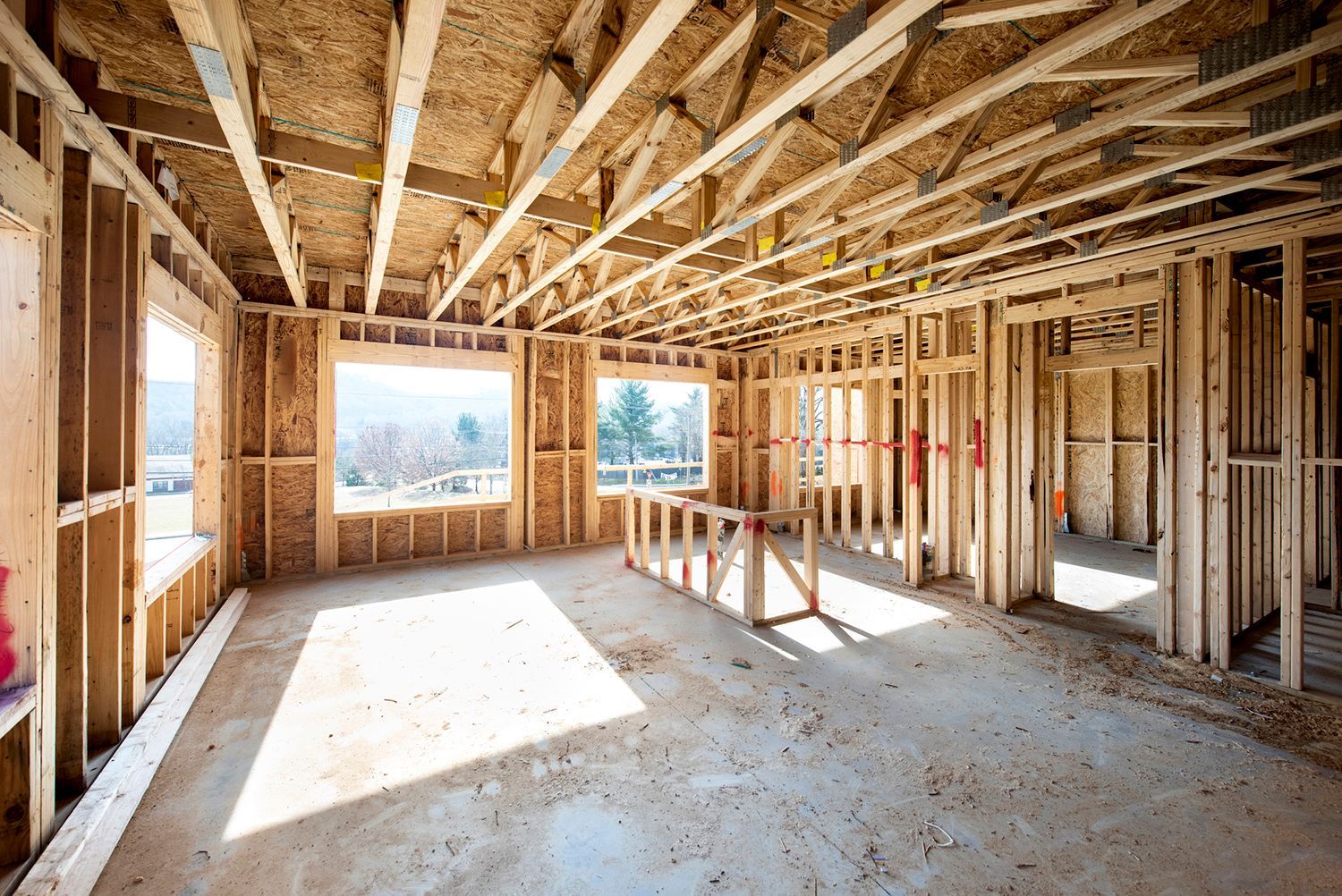 Inside view of a house being constructed with wood bare walls and floor.