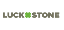 A logo for luck stone with a green clover in the middle.