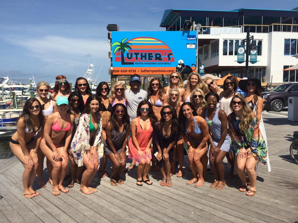 Large group of women standing in front of Luther's Pontoon sign in Destin FL