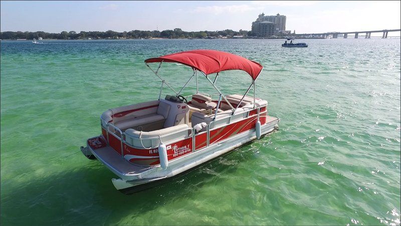 Red 20ft Pontoon boat rental anchored at beach in Destin FL