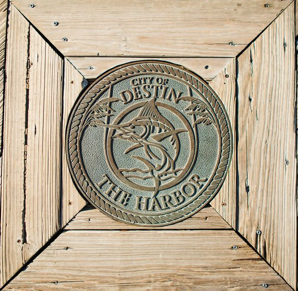 metal crest of swordfish with city of destin florida the harbor on wooden board