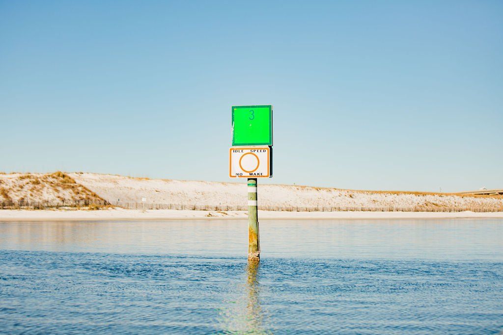 pole warning sign on water in destin, FL