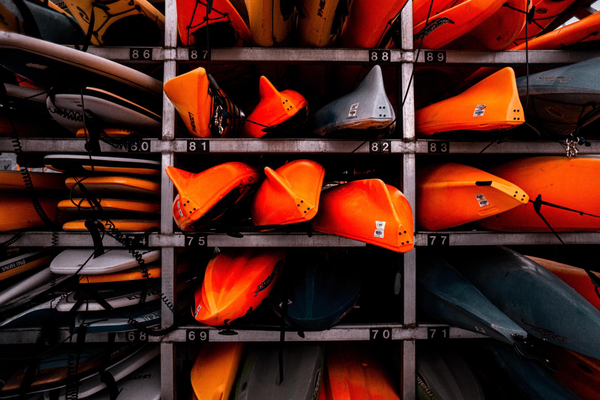 Storage rack with orange kayaks