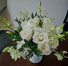 A vase filled with white roses and greenery on a table — Greenfield Blooms and Gifts In Wanguri, NT