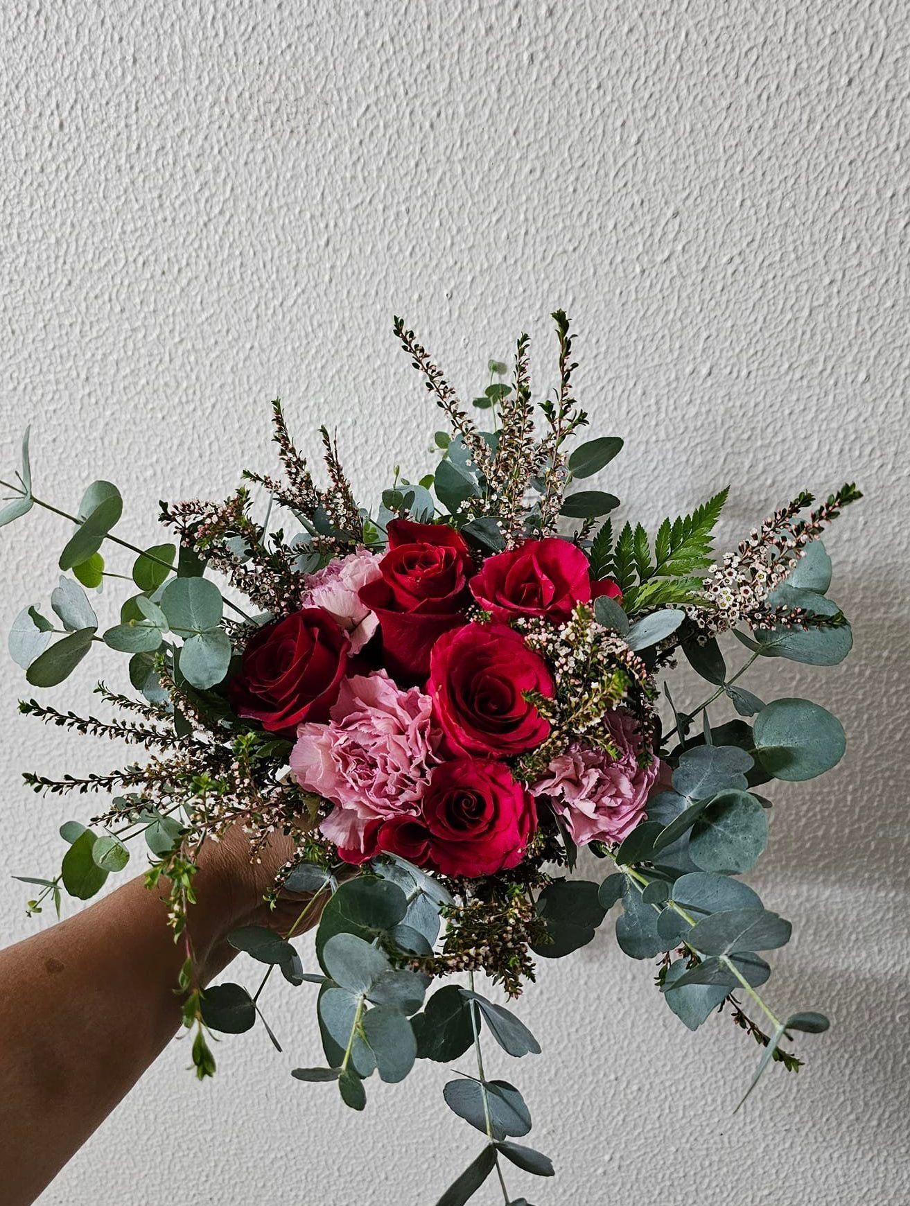 A Person is Holding a Bouquet of Red Roses and Pink Carnations — Greenfield Blooms and Gifts In Wanguri, NT