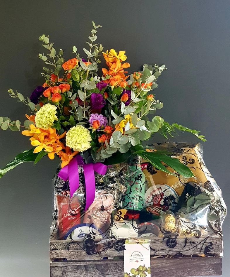 A Wooden Box Filled Wit h Flowers and a Purple Ribbon — Greenfield Blooms and Gifts In Wanguri, NT