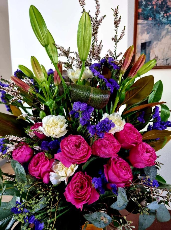 A Bouquet of Pink and Purple Flowers is Sitting on a Table — Greenfield Blooms and Gifts In Wanguri, NT