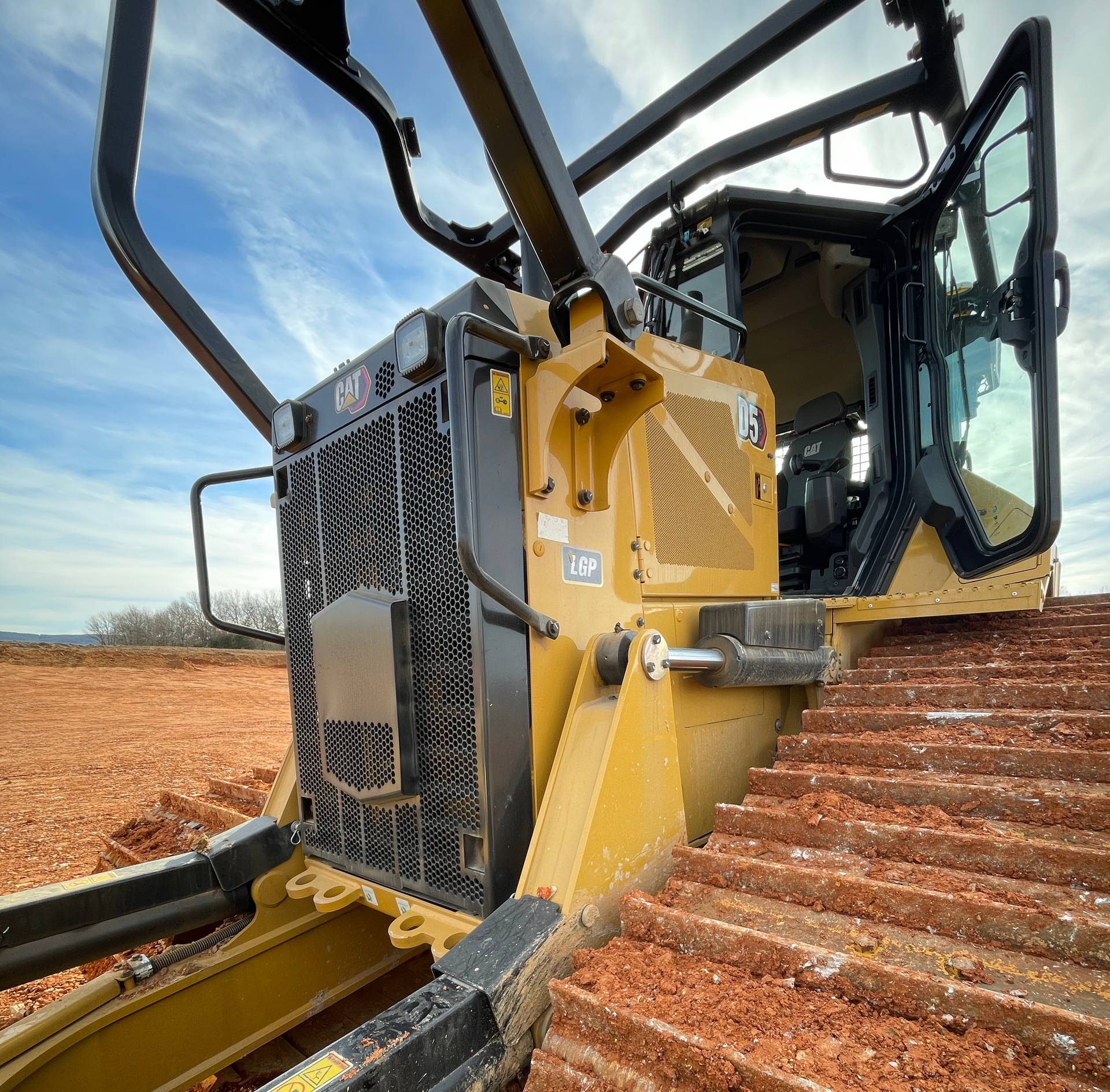 A bulldozer is sitting on top of a dirt field
