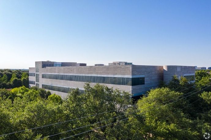 An aerial view of a large building surrounded by trees.