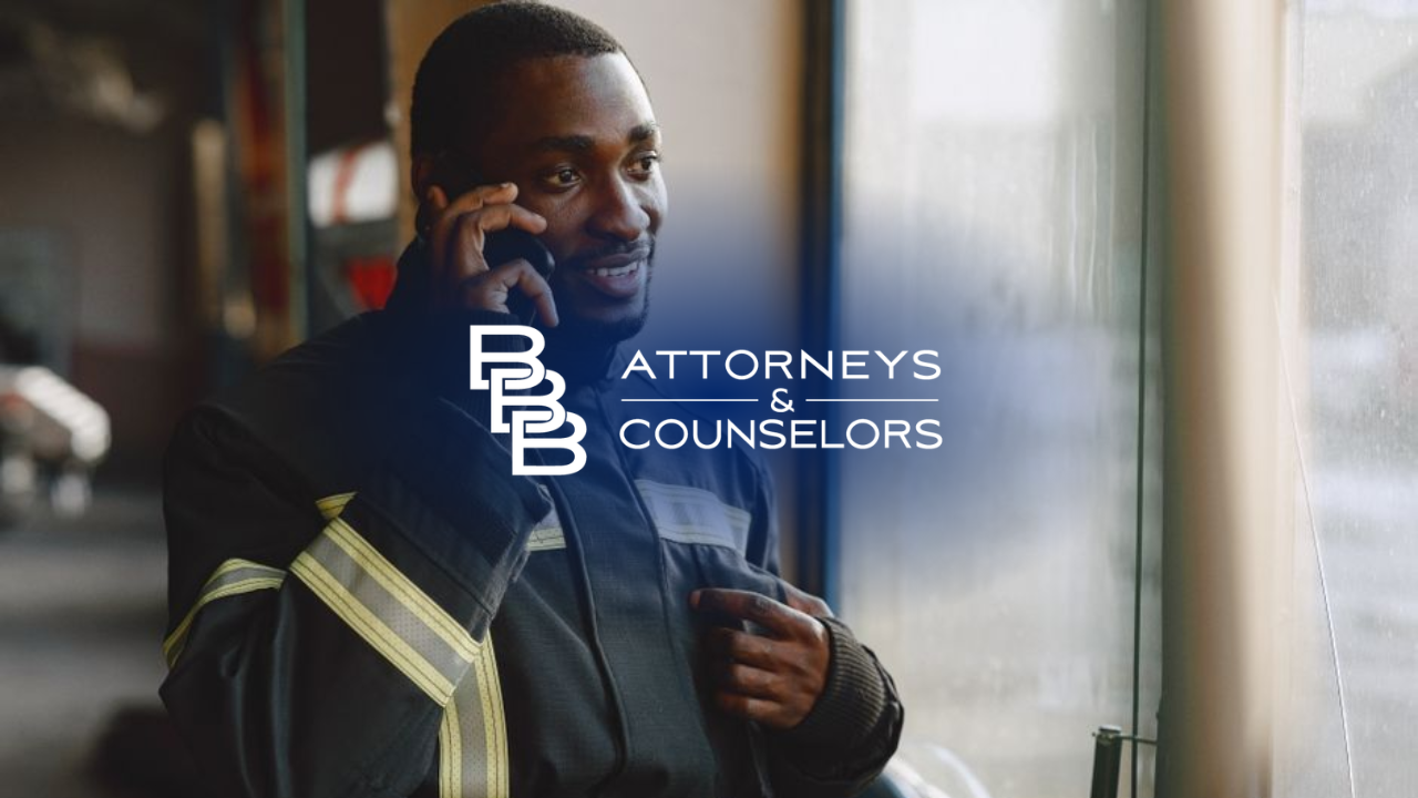 Attorney in a dark suit talking on a phone in a law office, with “ATTORNEYS & COUNSELORS” text overlay.