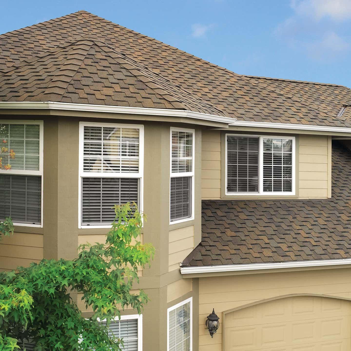 A house with a brown roof and lots of windows