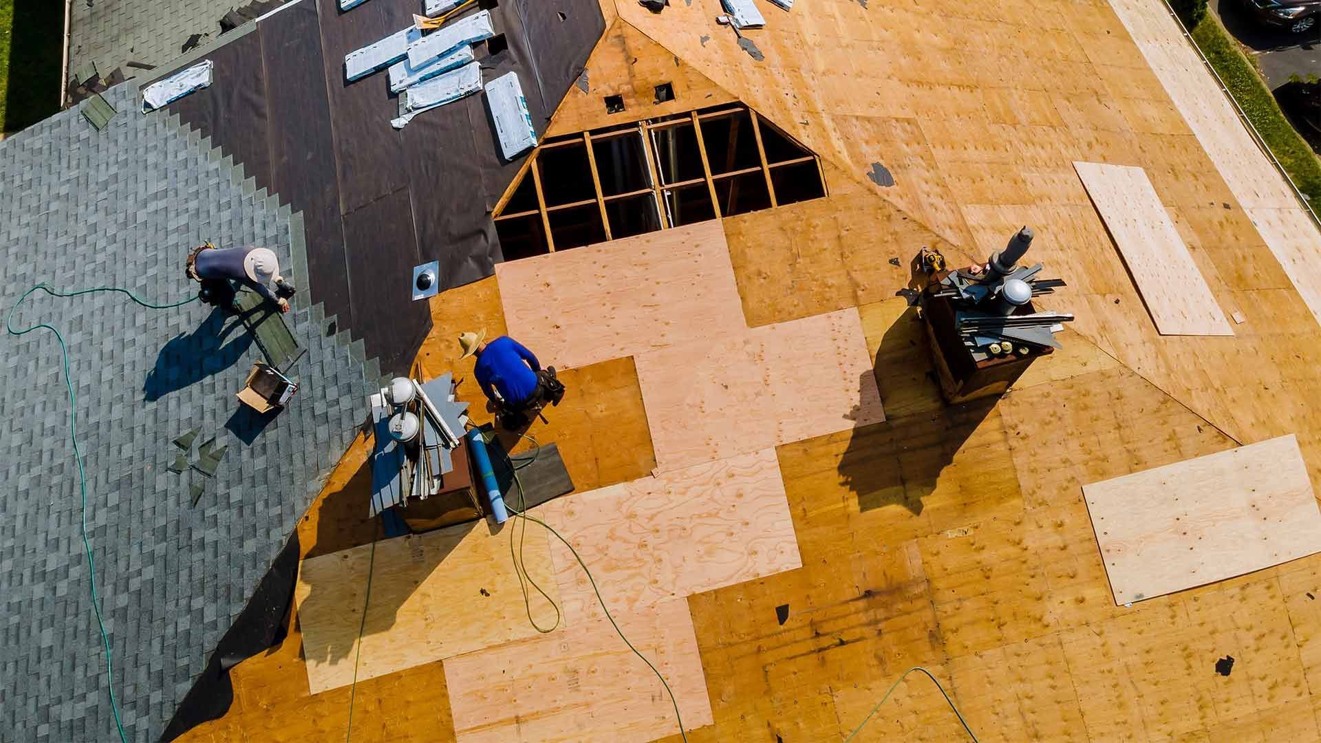 An aerial view of a roof being installed on a house.