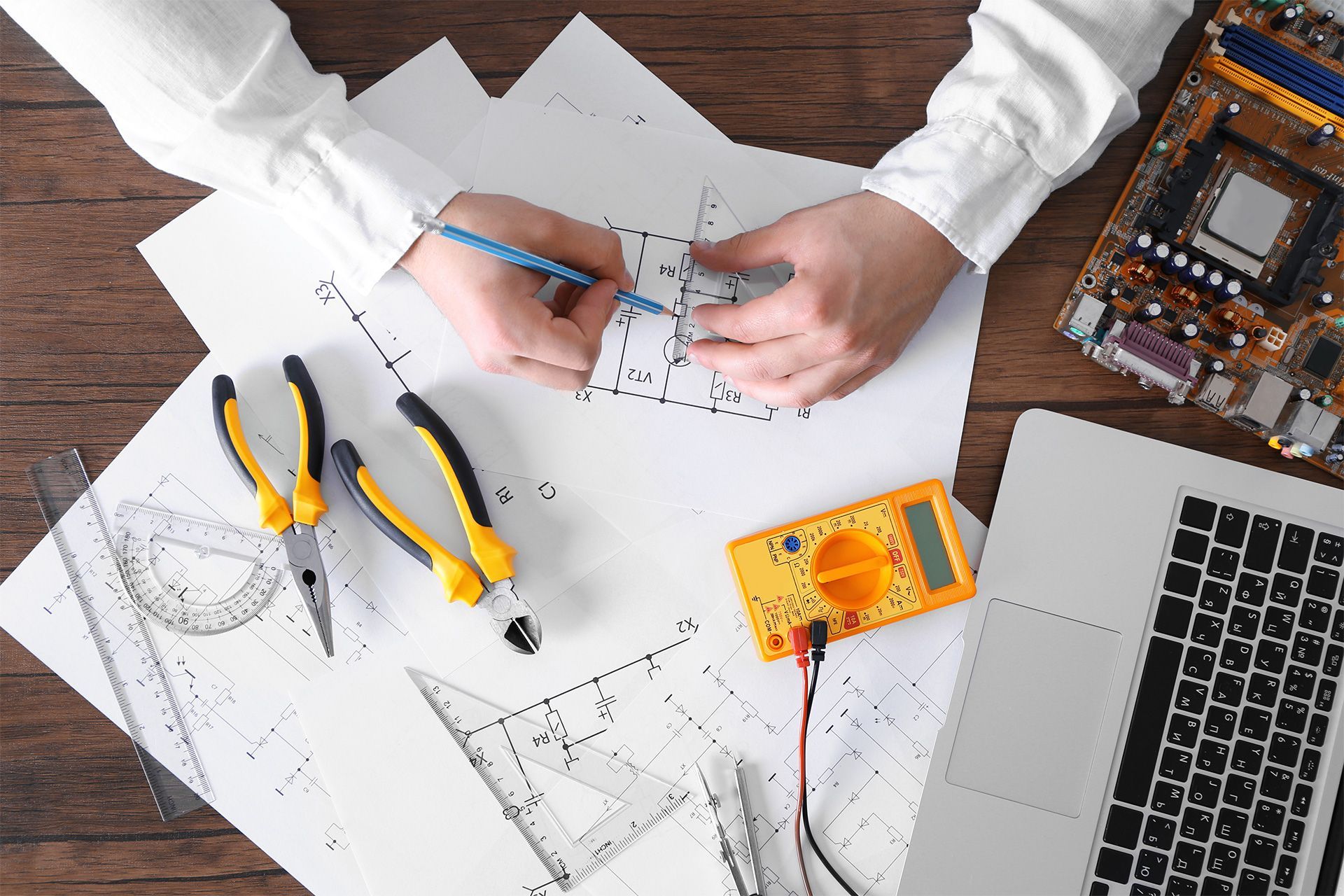 man drawing electrical blueprint