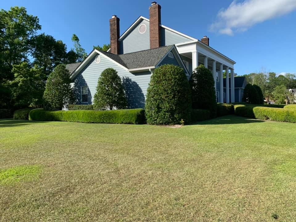 A large house with a large lawn in front of it