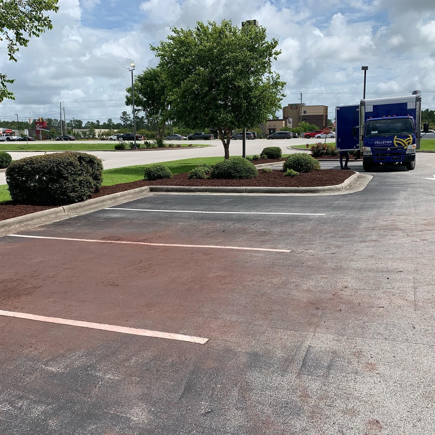 A blue truck is parked in a parking lot