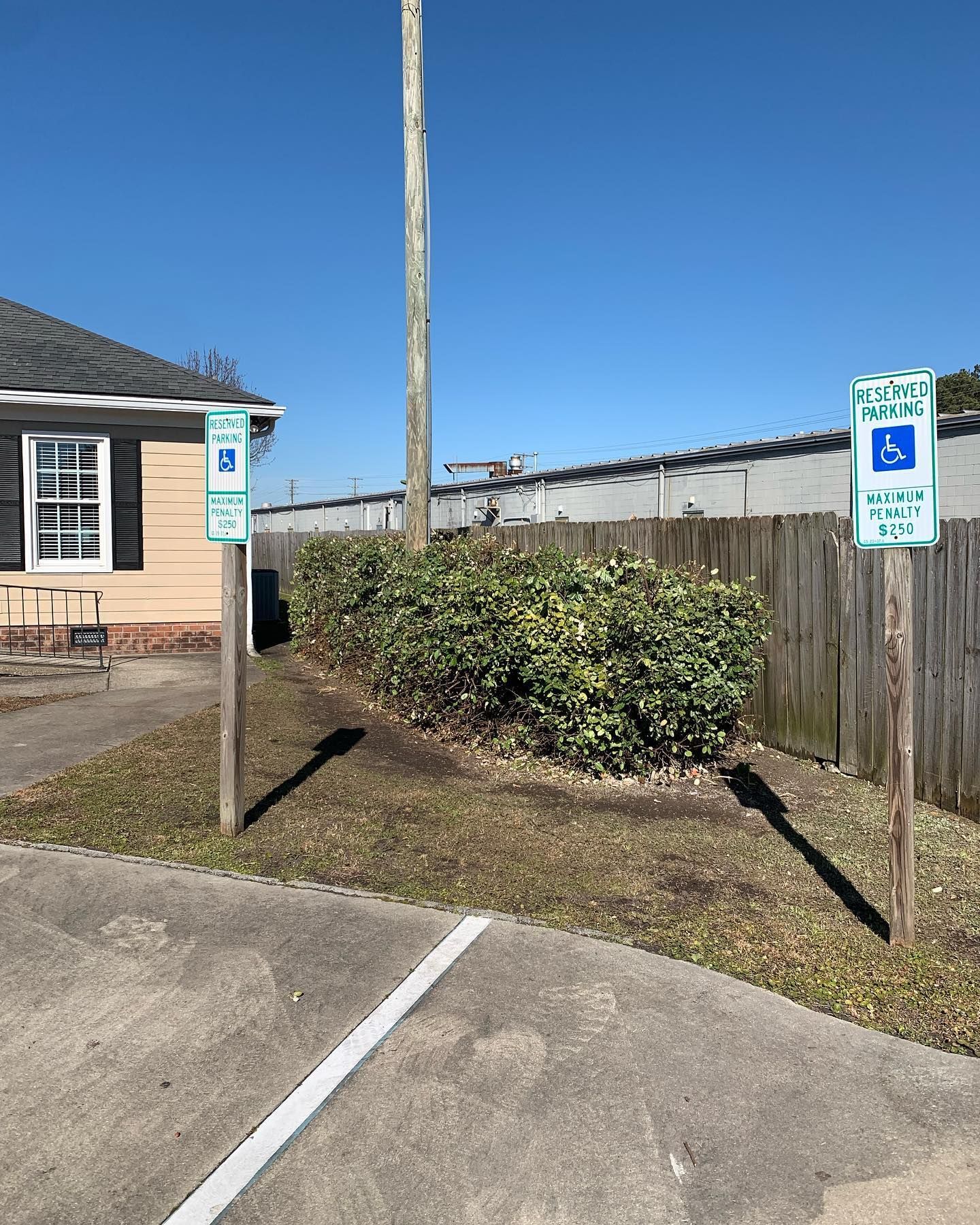 A handicapped parking spot is located in front of a house.