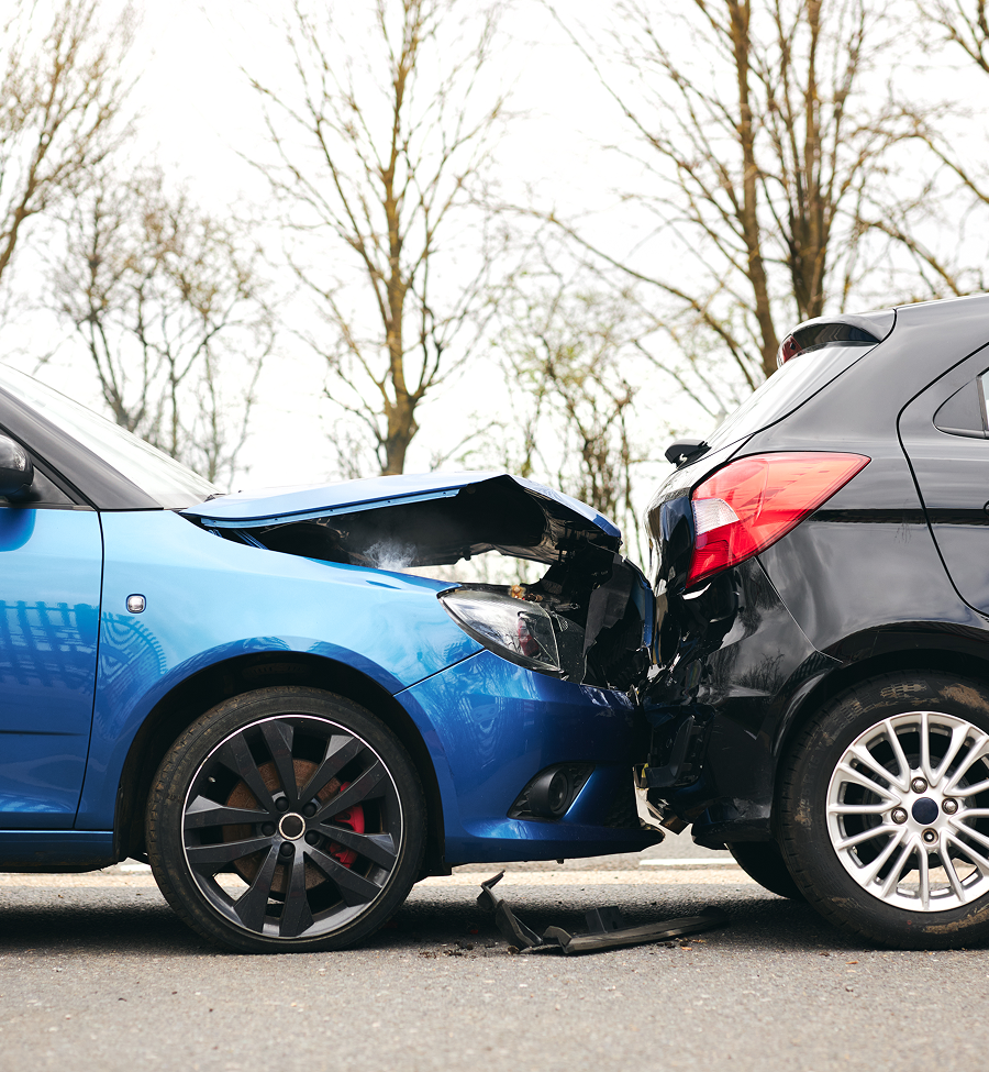 A blue car and a black car are involved in a car accident.