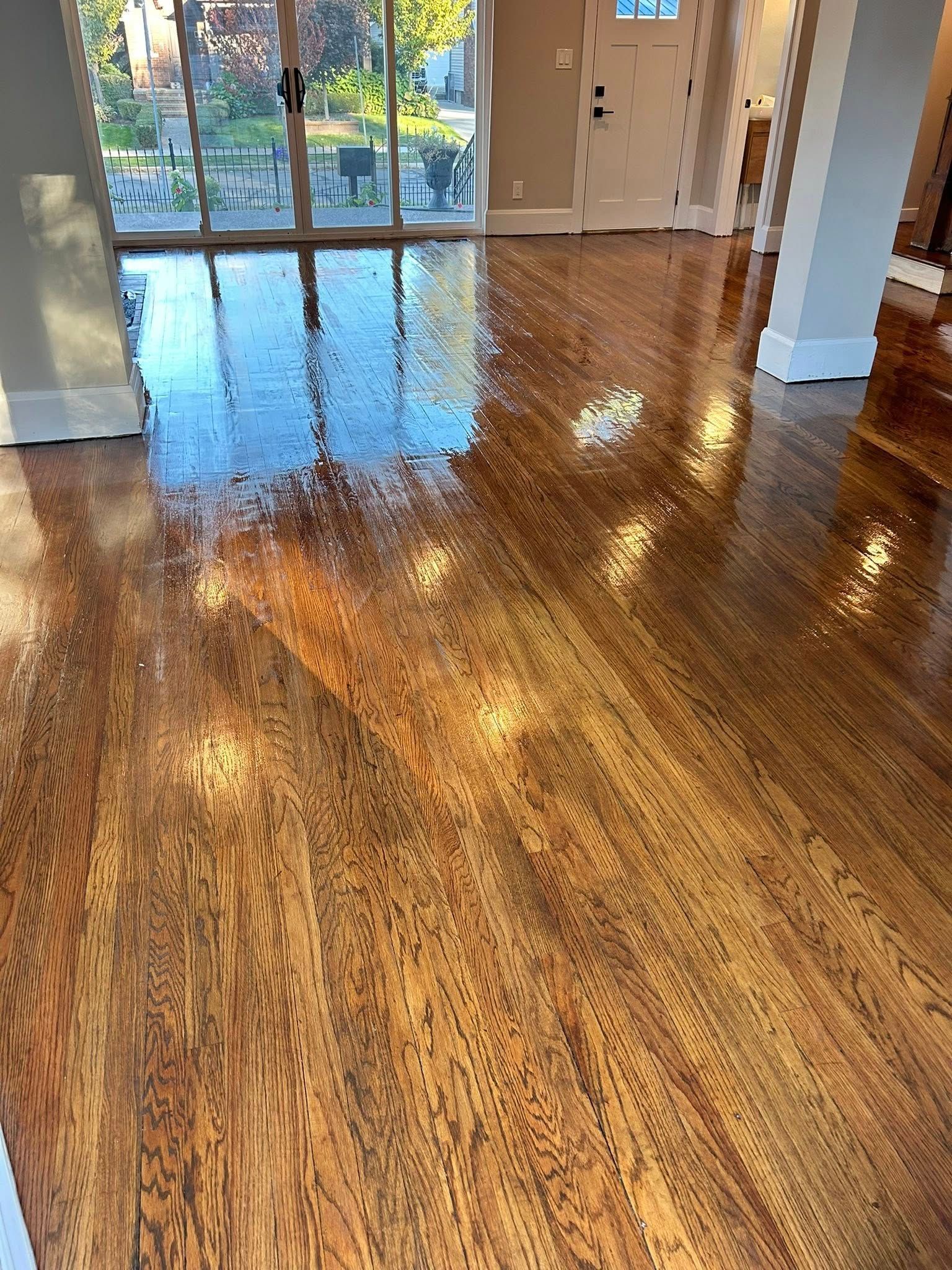 Shiny, hardwood floor reflecting light in a bright interior.