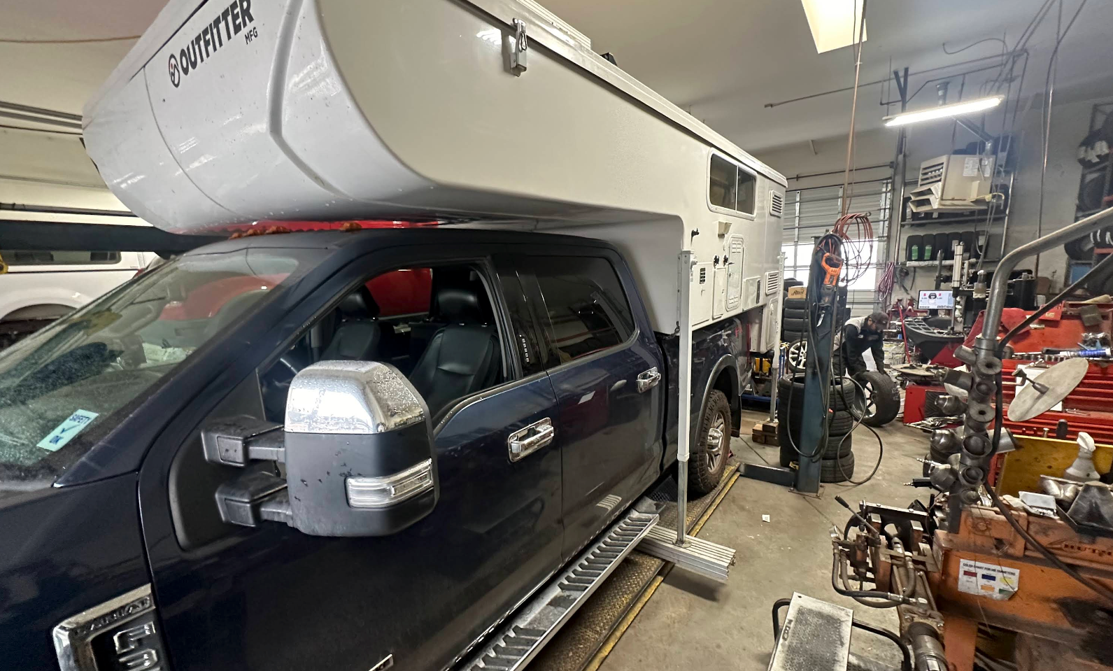 Truck with a Northwood Wolf Creek 850 Truck Camper | Amigo Tire and Auto