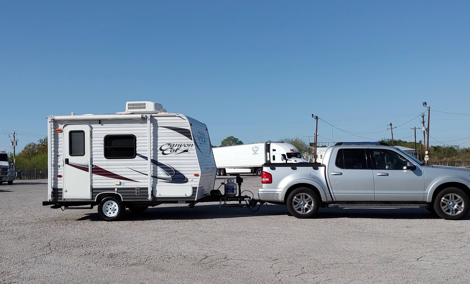 Silver Ford F-150 Pickup Truck Towing a Travel Trailer | Amigo Tire and Auto