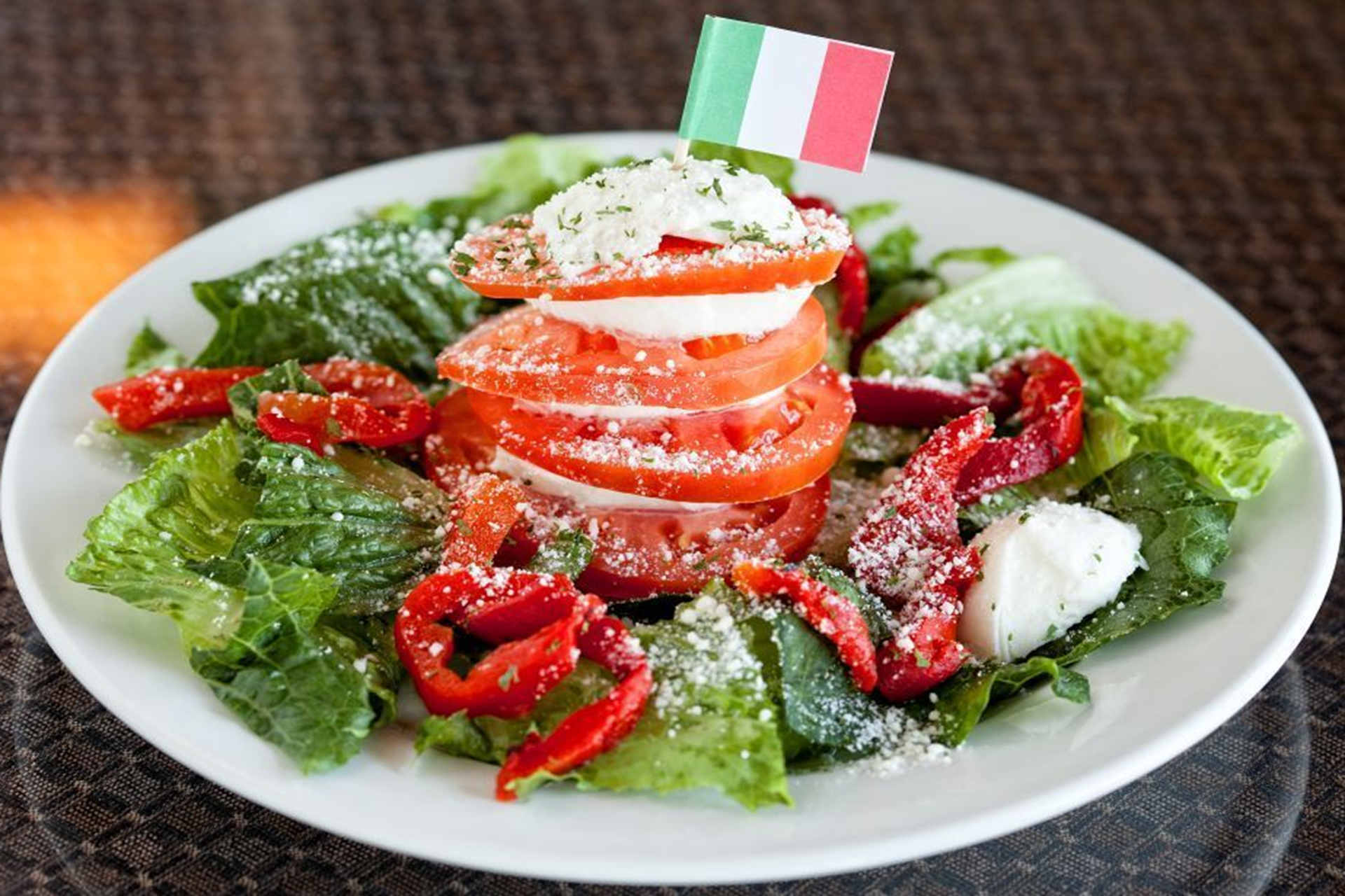 Romaine lettuce topped with roasted red peppers, fresh mozzarella and sliced tomatoes.