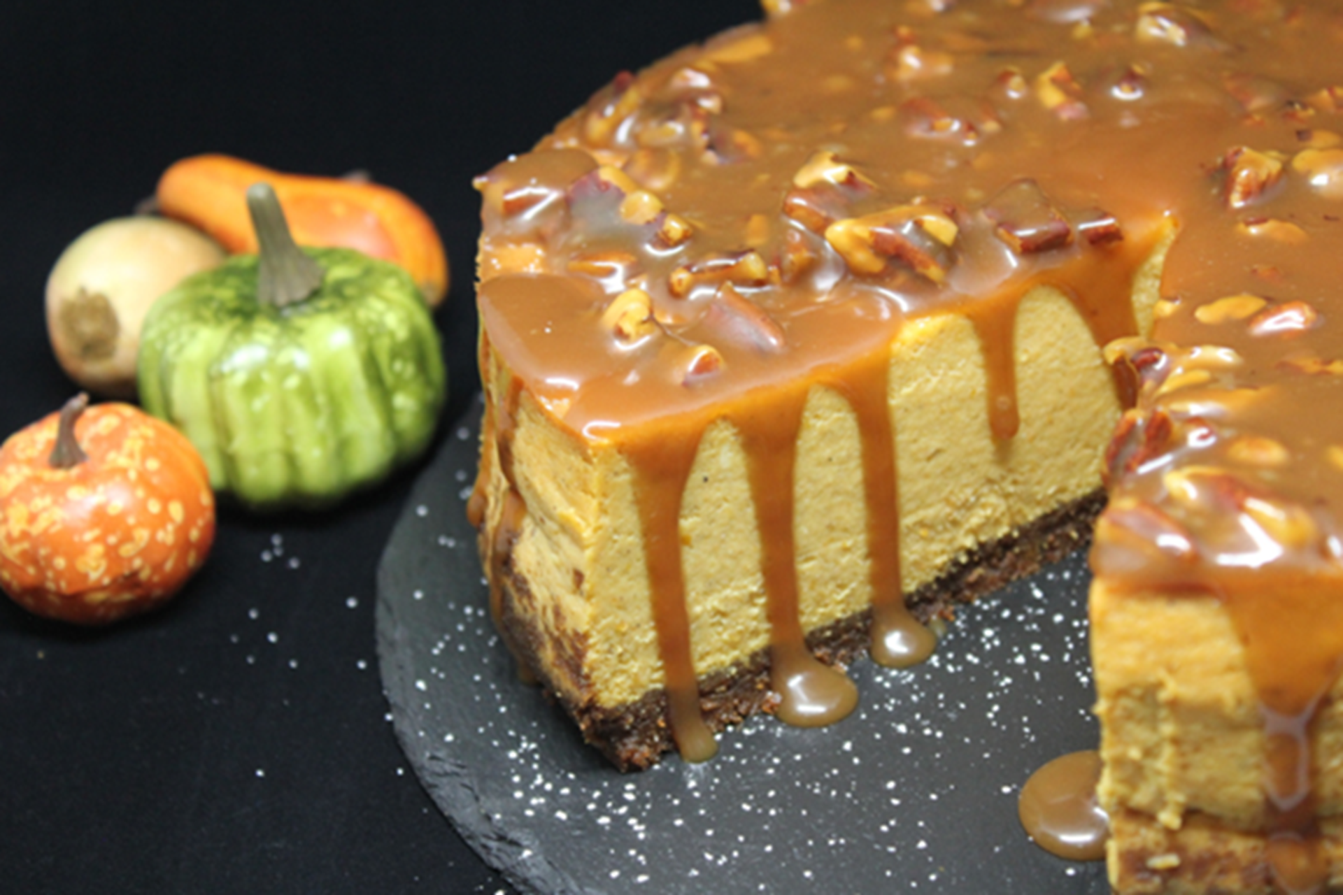 Pumpkin Cheesecake with Bourbon Pecan Caramel Sauce