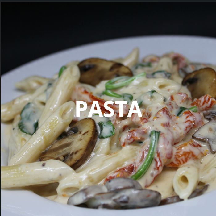 A plate of creamy penne pasta tossed in rich Alfredo sauce, featuring sautéed mushrooms, sun dried tomatoes, and wilted spinach. The combination of flavors and textures creates a delicious and visually appealing dish, perfect for a gourmet meal