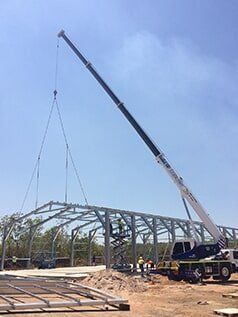 Crane installing trusses in field — Build Up Crane Hire in Casuarina, NT