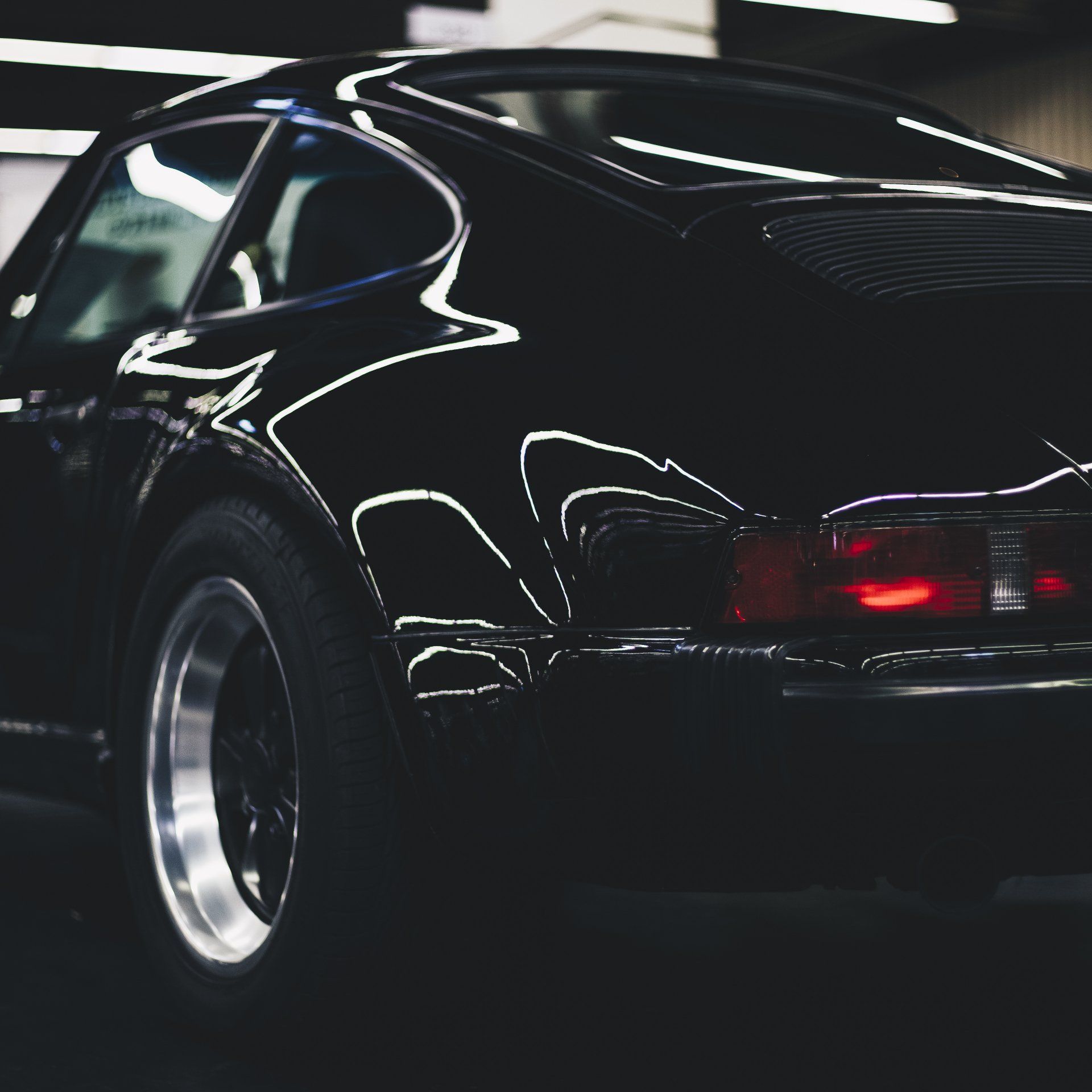Gleaming black car reflecting brilliance, polished to perfection.