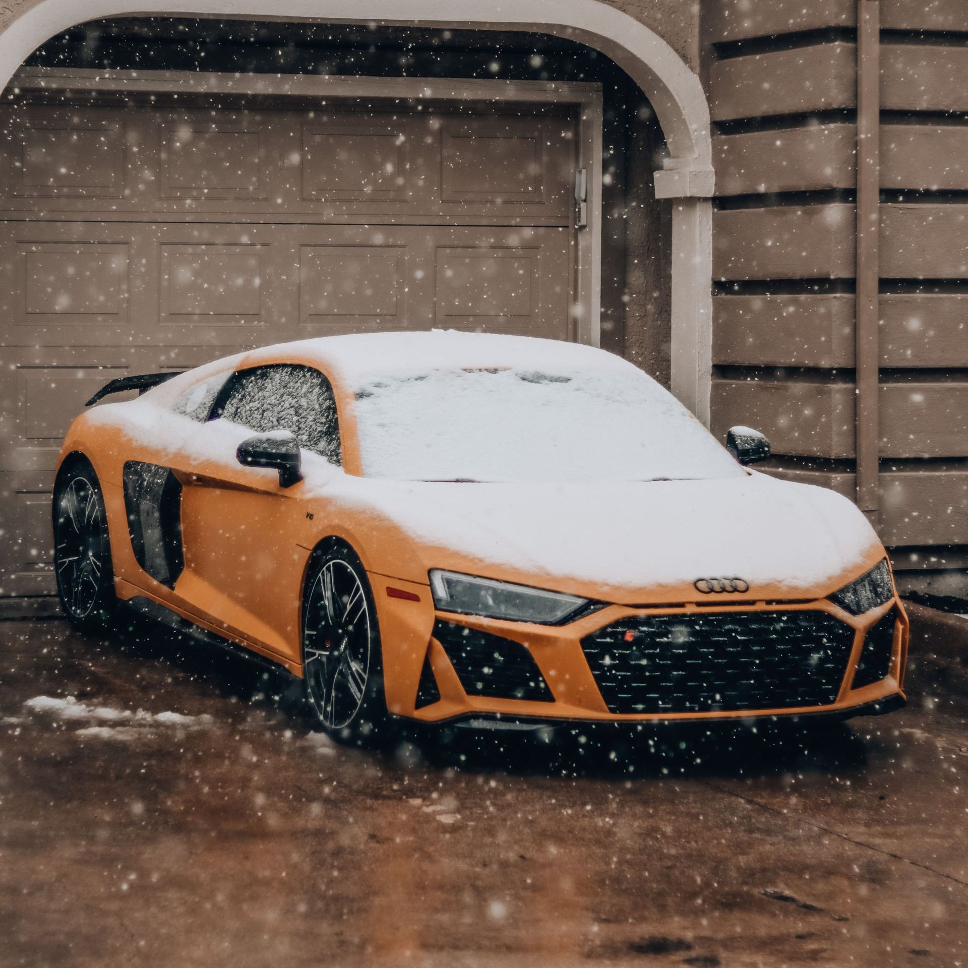 Supercar covered in snow, winter conditions.