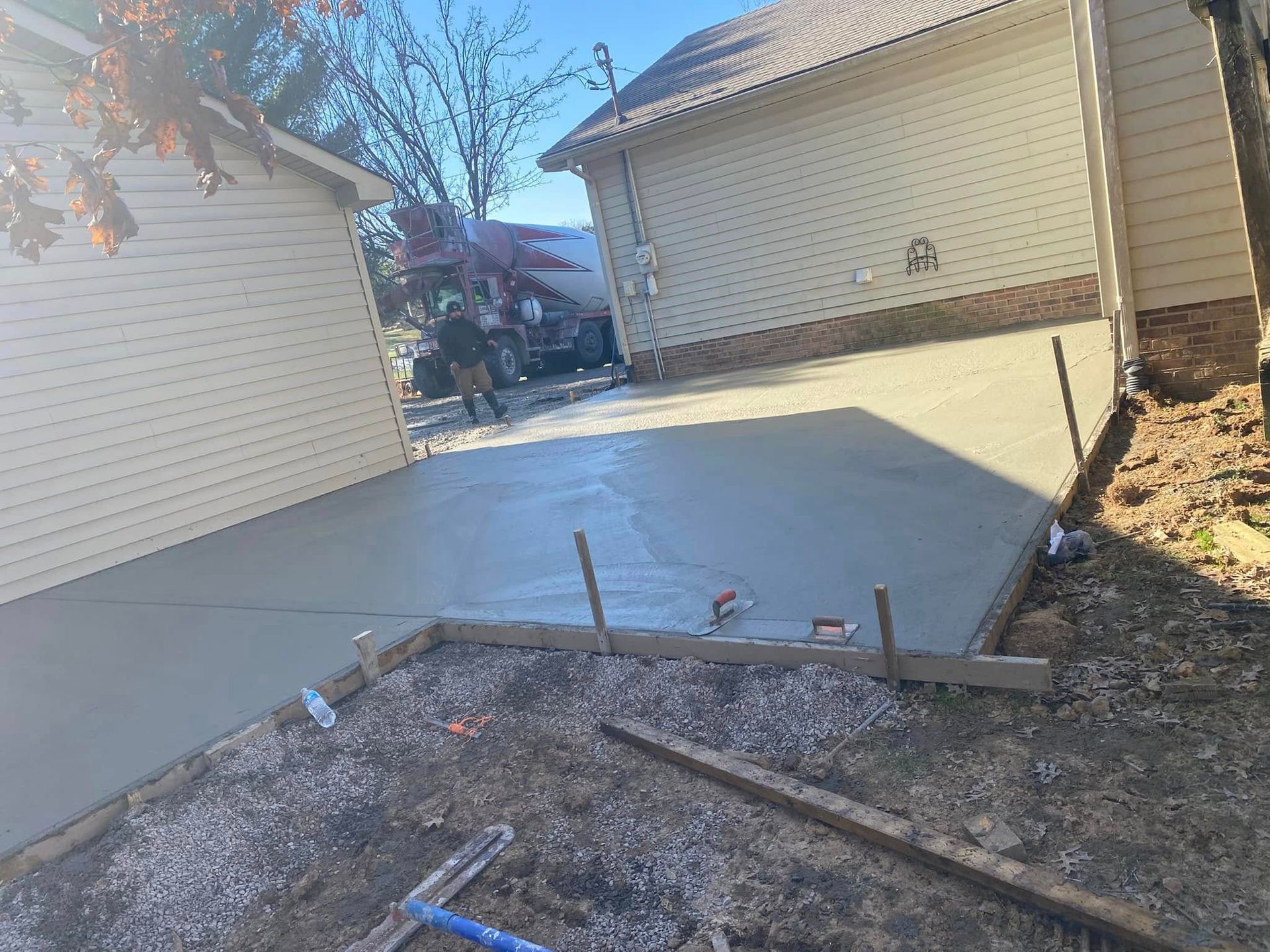 Martinez Construction | A concrete driveway is being built in front of a house.