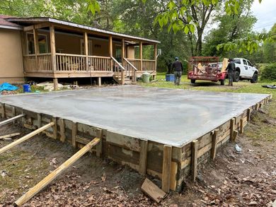 Martinez Construction | A large concrete slab is being built in front of a house.