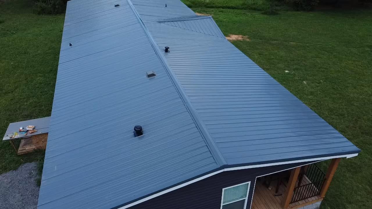 Martinez Construction | An aerial view of a house with a blue roof and a porch.