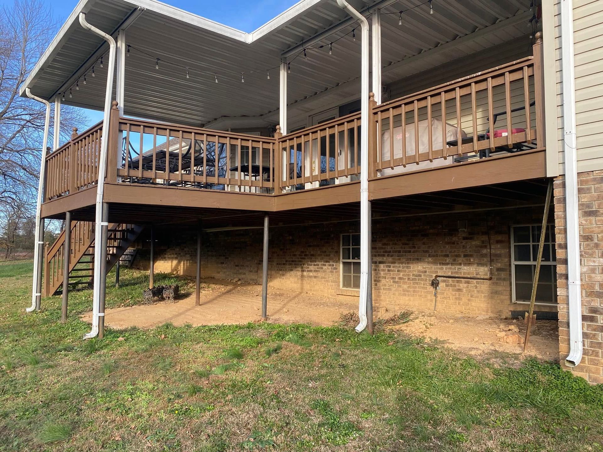 Martinez Construction | A house with a large deck and stairs on the side of it.