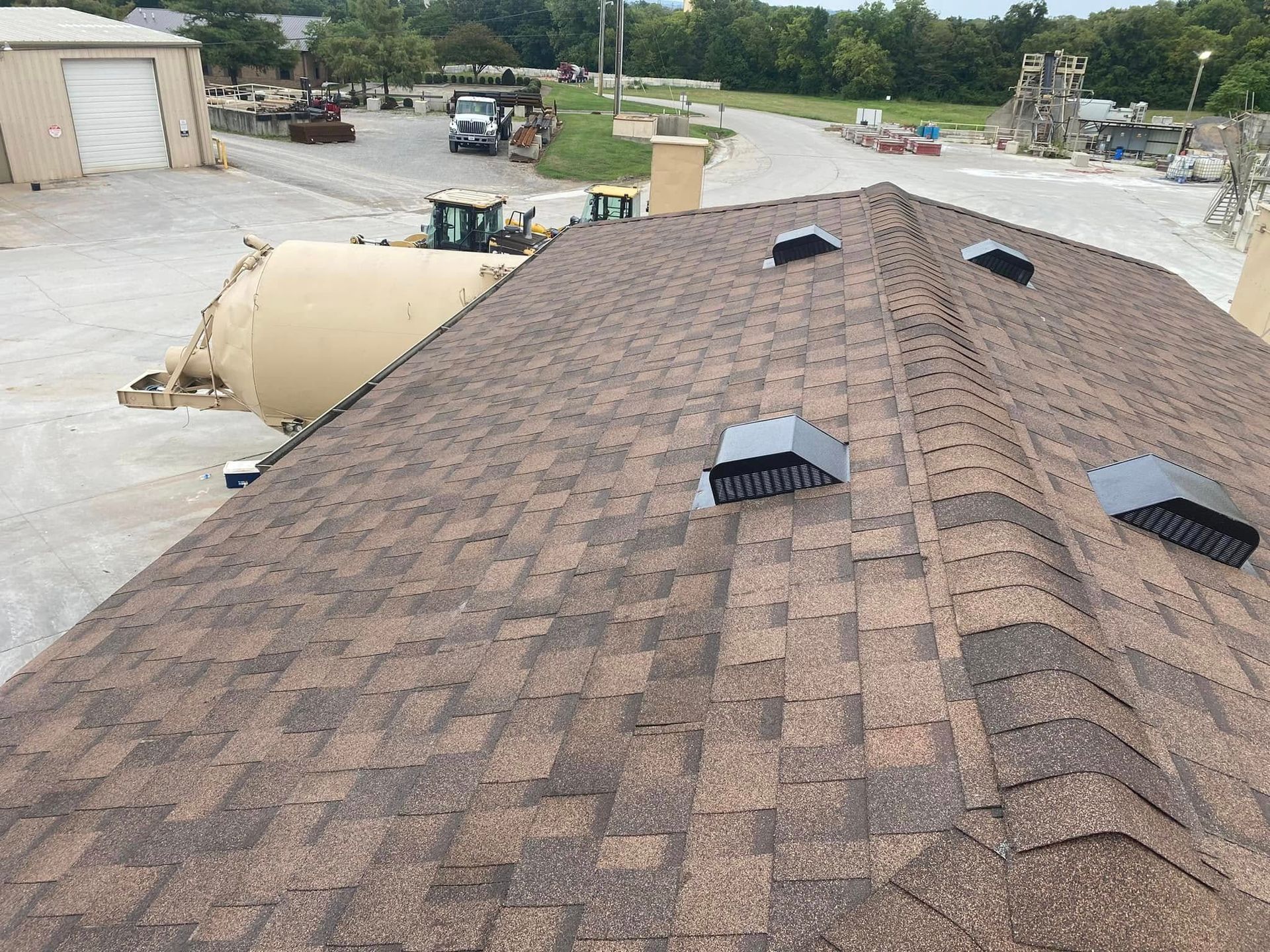 Martinez Construction | An aerial view of a roof with a tractor in the background.